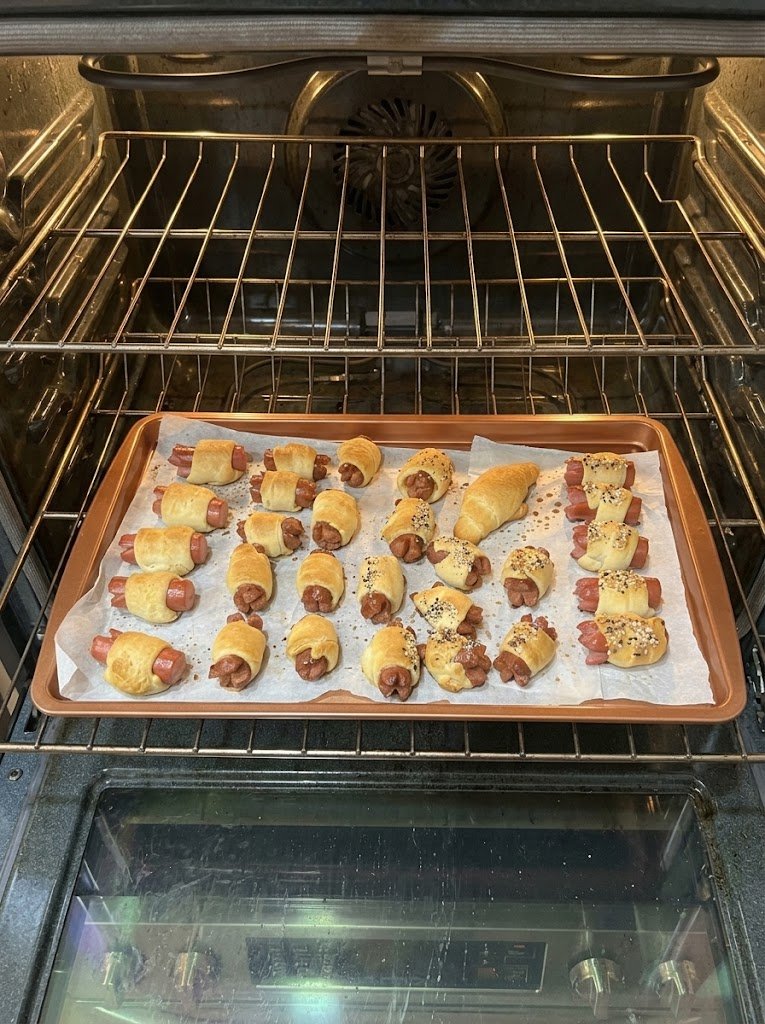Golden brown pigs in a blanket baked with crescent roll dough