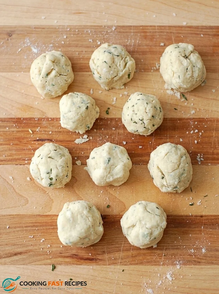 Shaping soft herb dumpling dough into small balls for beef stew