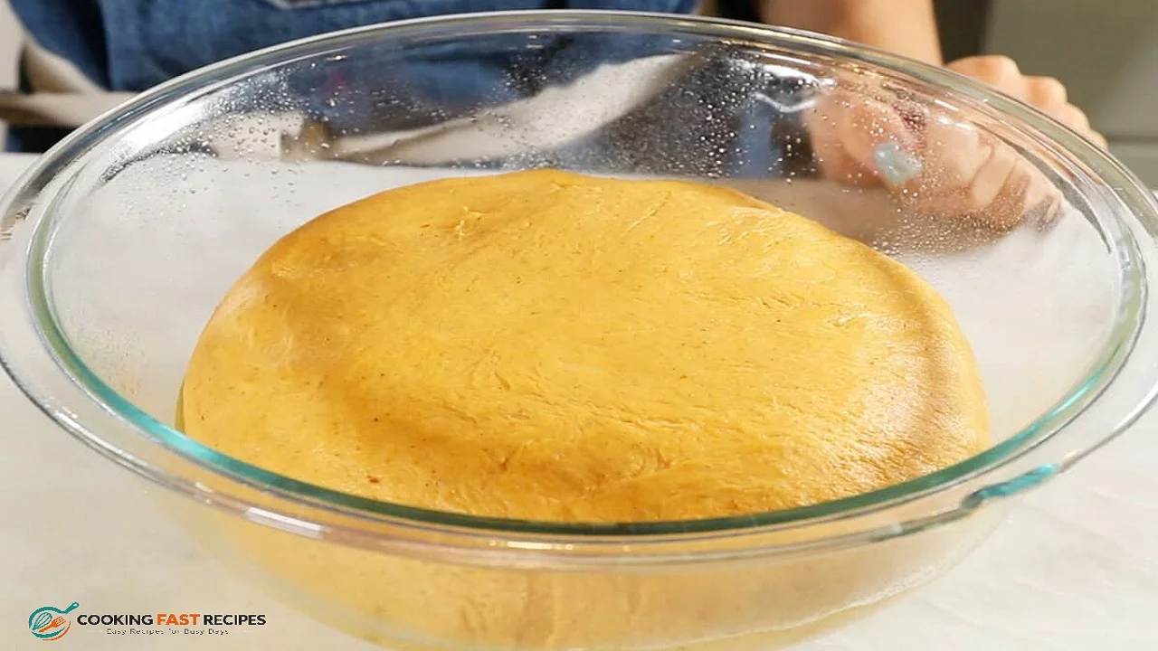 Soft pumpkin cinnamon roll dough in a mixing bowl