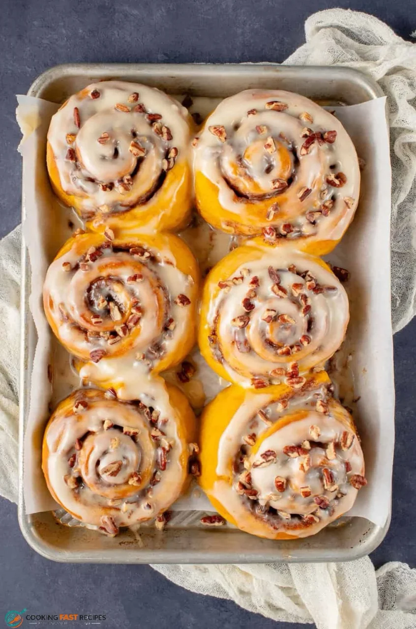 Frosted pumpkin cinnamon roll with soft cinnamon layers